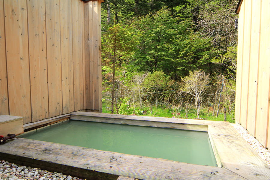 奥日光湯元温泉 かつら荘 — 栃木県日光市湯元 · 木塀に囲まれた露天風呂に満たされたエメラルドグリーンの硫黄泉