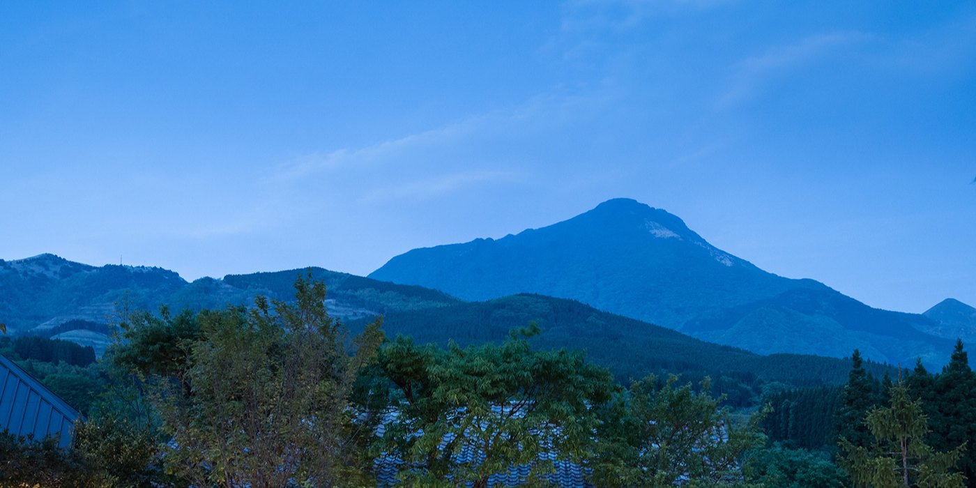 湯富里の宿 一壺天 — 由布院・川上 · 宿の敷地から望む夕暮れの由布岳